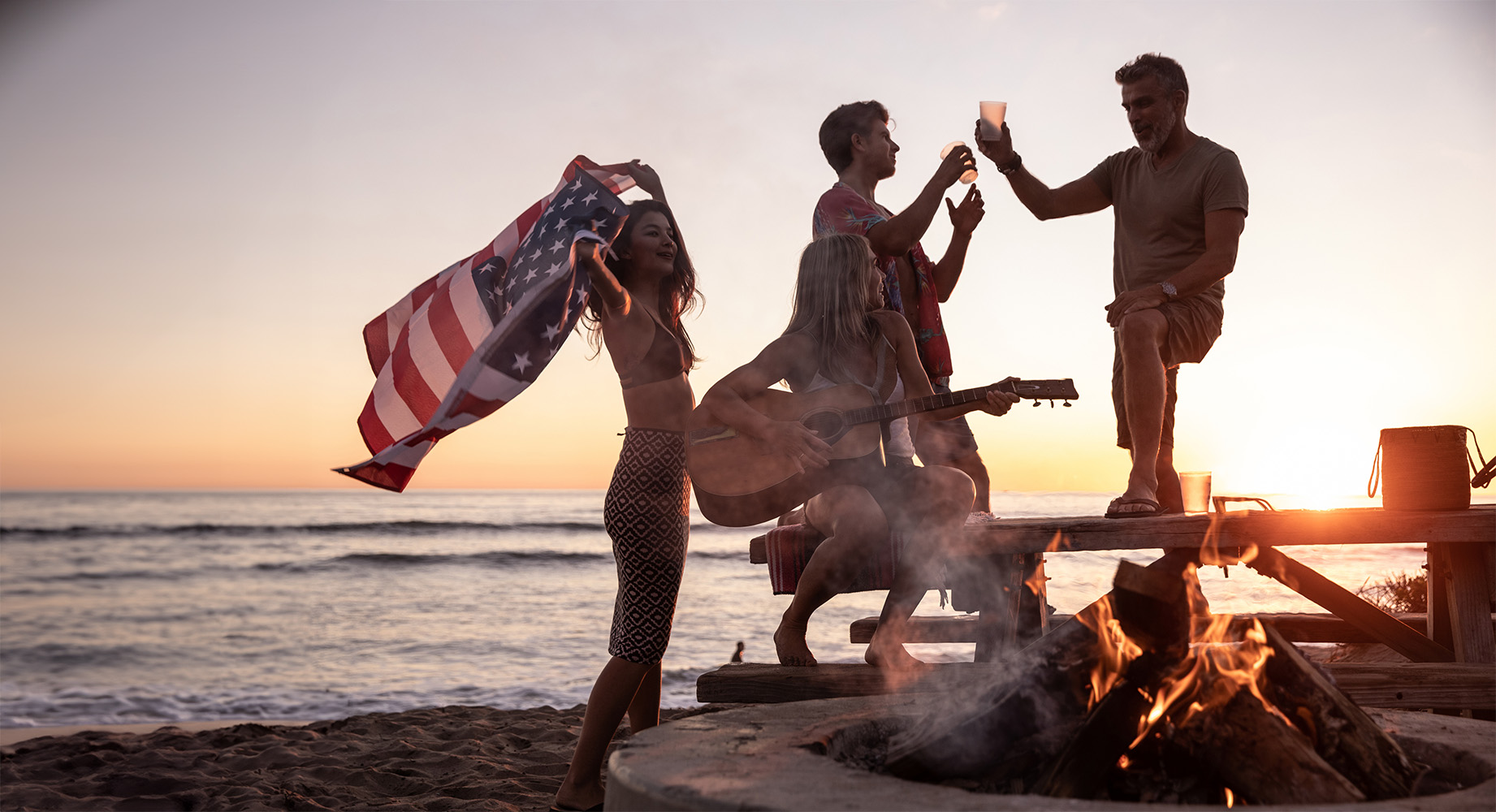 Partygoers enjoying drinks on the beach